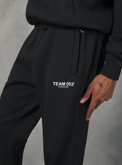 Heren Alcott bg1 beige donker joggingbroek met team 053 print kleding PT24757