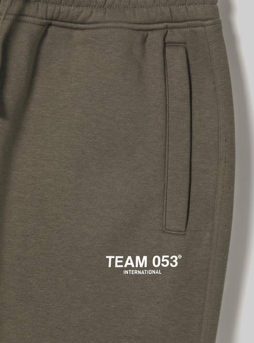 Heren Alcott bg1 beige donker joggingbroek met team 053 print kleding PT24769